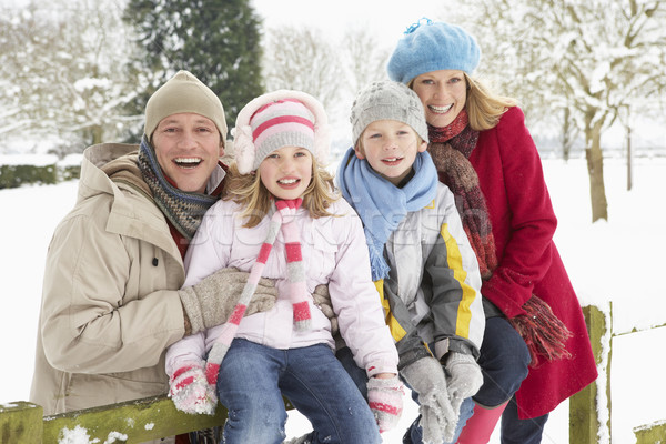 Stock photo: Family Sitting In Snowy Landscape