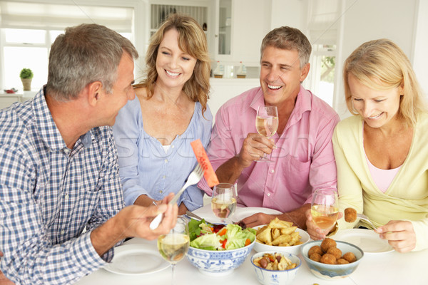 Mid age couples enjoying meal at home Stock photo © monkey_business
