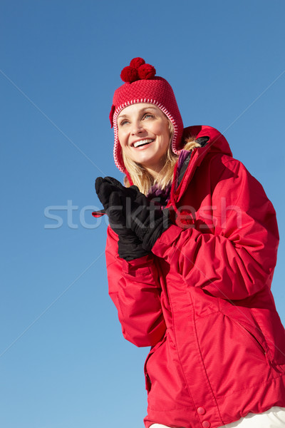 Woman Standing In Snow Wearing Warm Clothes On Ski Holiday In Mo Stock photo © monkey_business