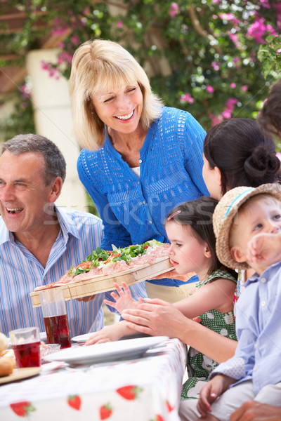 Senior Woman Serving At Multi Generation Family Meal Stock photo © monkey_business