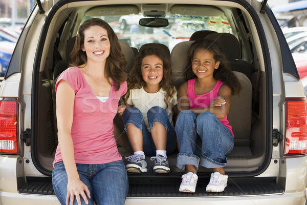 Woman with two young girls sitting in back of van smiling Stock photo © monkey_business