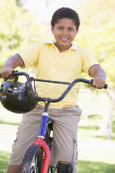 Stock photo: Young boy on bicycle outdoors smiling