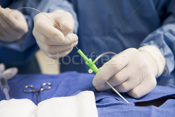 Surgeon Inserting Tube Into Patient During Surgery Stock photo © monkey_business