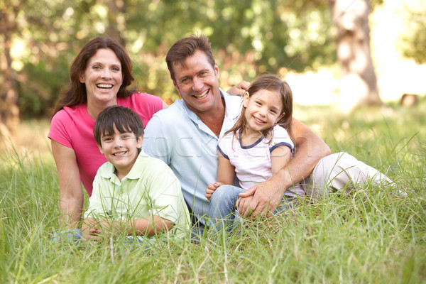 Famille séance longtemps herbe parc femme [[stock_photo]] © monkey_business