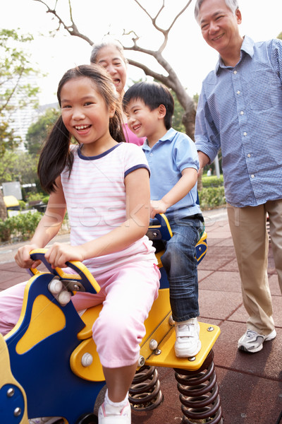 Chinois grands-parents jouer petits enfants aire de jeux enfant [[stock_photo]] © monkey_business