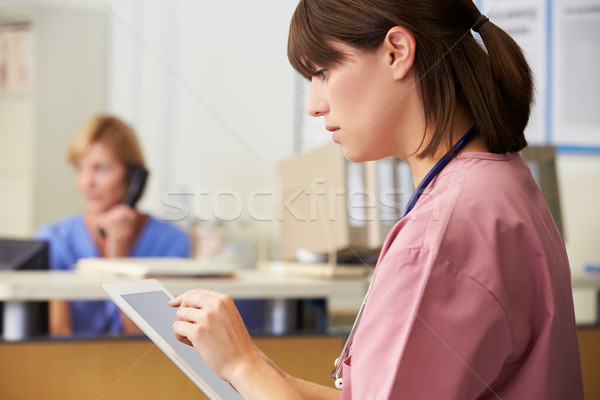 Stock photo: Nurse Using Digital Tablet At Nurses Station