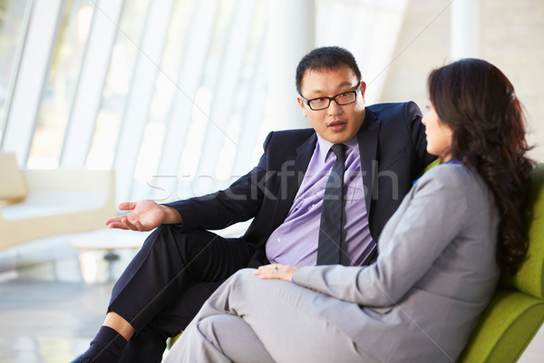 Businesspeople Sitting On Sofa In Modern Office Stock photo © monkey_business