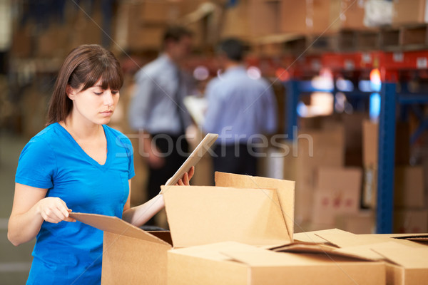 Worker In Warehouse Checking Boxes Using Digital Tablet Stock photo © monkey_business
