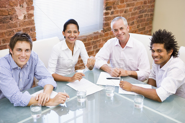 Quatro sala de reuniões sorridente homem tabela Foto stock © monkey_business