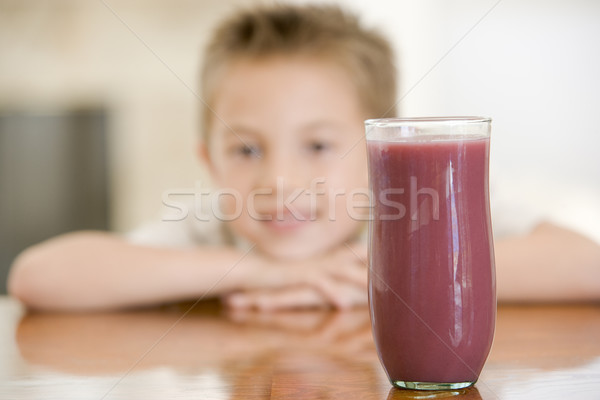 Young boy indoors with focus on juice glass Stock photo © monkey_business