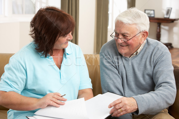 Stock photo: Senior Man In Discussion With Health Visitor At Home
