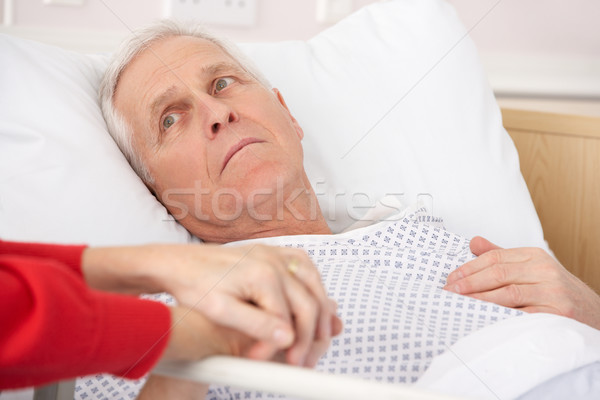 Idős férfi kórházi ágy tart kéz orvosi Stock fotó © monkey_business