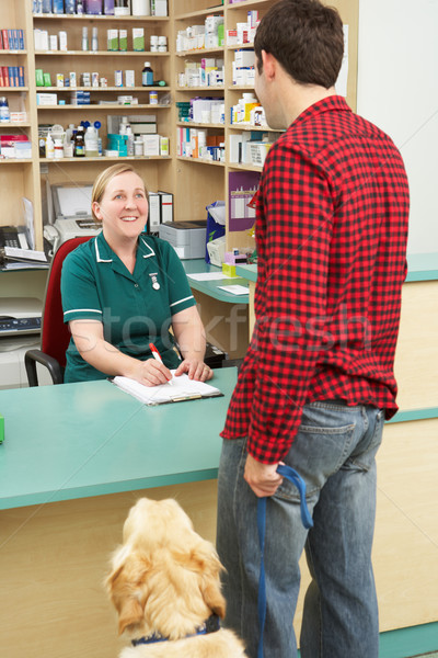 Man Making Appointment At Reception Of Veterinary Surgery Stock photo © monkey_business
