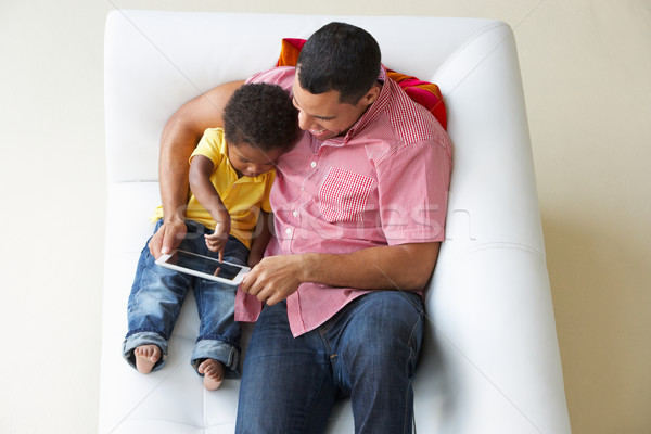 Overhead View Of Father And Son On Sofa Using Digital Tablet Stock photo © monkey_business