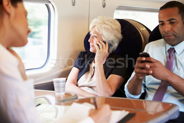 Businesswoman Using Mobile Phone On Busy Commuter Train Stock photo © monkey_business