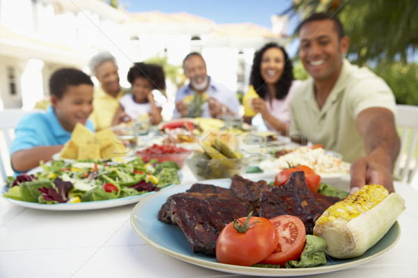 Famiglia mangiare affresco pasto donne felice Foto d'archivio © monkey_business