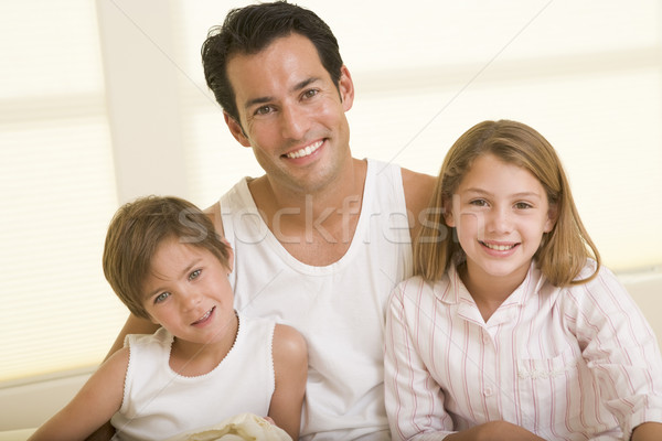 Man with two young children sitting in bed smiling Stock photo © monkey_business