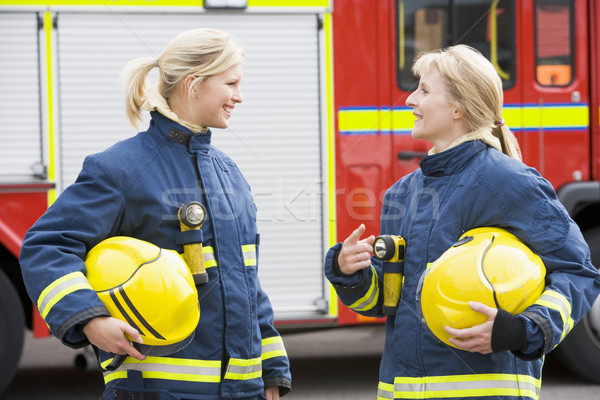 Dois feminino bombeiros carro de bombeiros sorridente capacete Foto stock © monkey_business
