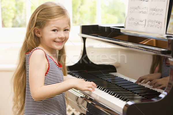 Jeune fille jouer piano fille enfant salon [[stock_photo]] © monkey_business