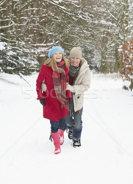 Couple Walking Through Snowy Woodland Stock photo © monkey_business