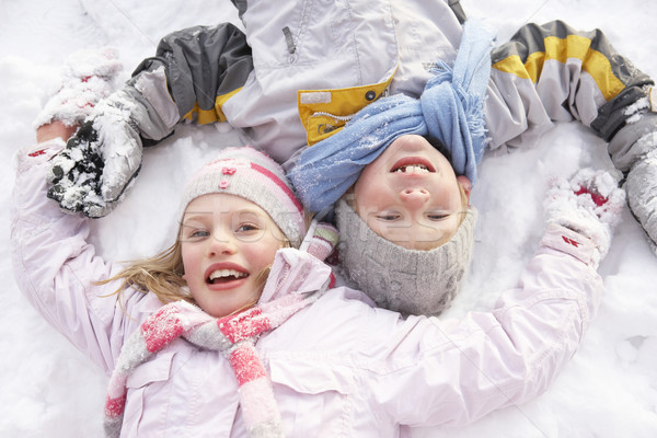Children Laying On Ground Making Snow Angel Stock photo © monkey_business