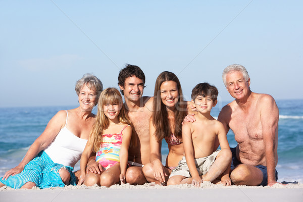 Three Generation Family On Holiday Walking Along Beach Stock photo © monkey_business