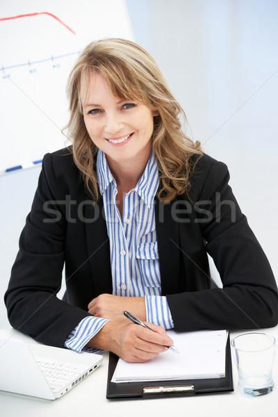 Mid age businesswoman at work Stock photo © monkey_business