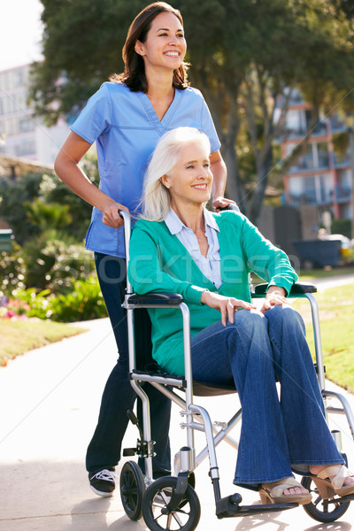 Carer Pushing Senior Woman In Wheelchair Stock photo © monkey_business