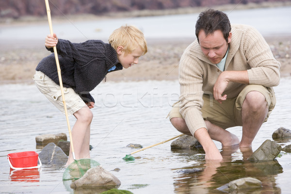 Father and son at beach fishing Stock photo © monkey_business