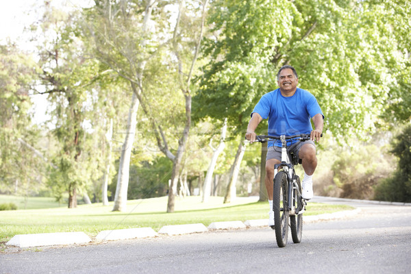 старший человека Велоспорт парка счастливым велосипед Сток-фото © monkey_business