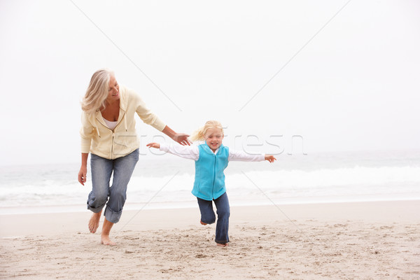 Grand-mère petite fille courir hiver plage fille [[stock_photo]] © monkey_business