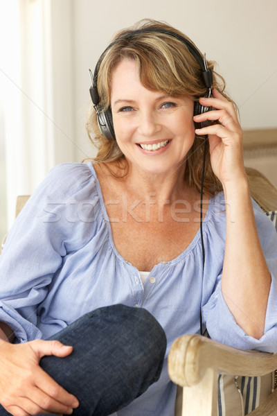Mid age woman wearing headphones Stock photo © monkey_business