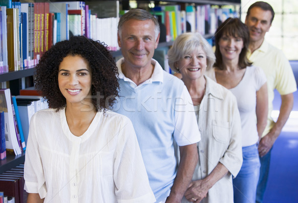 Studentii adulti în picioare bibliotecă carte student educaţie Imagine de stoc © monkey_business