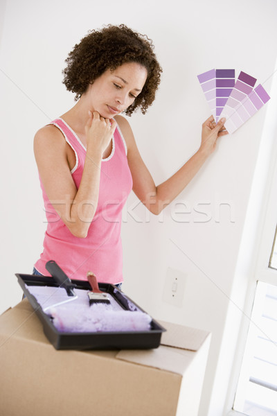 Woman with paint swatches in new home thinking Stock photo © monkey_business