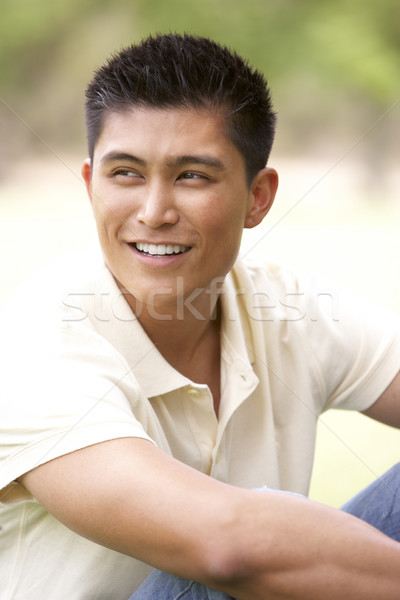 Stock photo: Portrait Of Young Man Sitting In Park