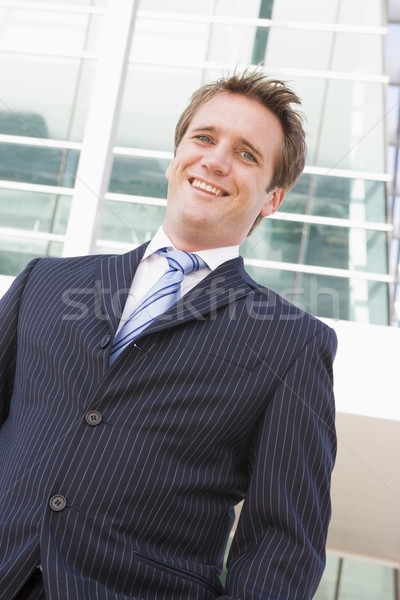 Businessman standing outdoors smiling Stock photo © monkey_business