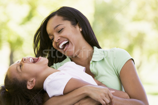 Woman and young girl outdoors embracing and laughing Stock photo © monkey_business