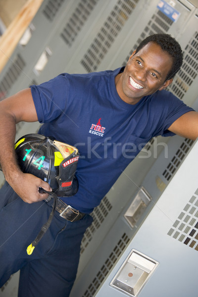 Stock photo: Portrait of a firefighter in the fire station locker room