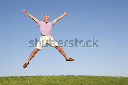 Senior woman  jumping in air Stock photo © monkey_business