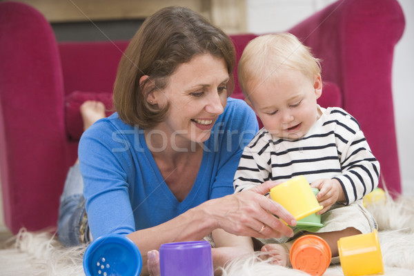 Mother in living room playing with baby smiling Stock photo © monkey_business