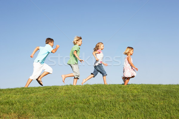 Jovem crianças corrida campo céu primavera Foto stock © monkey_business