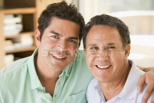 Stock photo: Two men in living room smiling