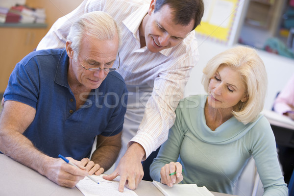 Teacher assisting mature students in class Stock photo © monkey_business