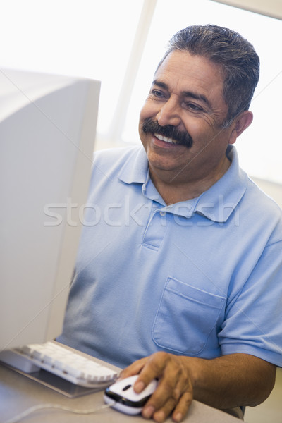 Mature male student learning computer skills Stock photo © monkey_business