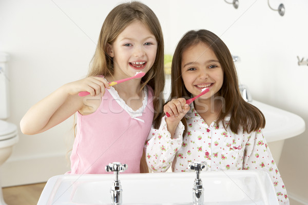 Two Young Girls Brushing Teeth at Sink Stock photo © monkey_business