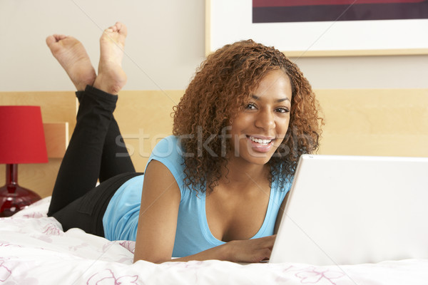 Stock photo: Teenage Girl Using Laptop In Bedroom