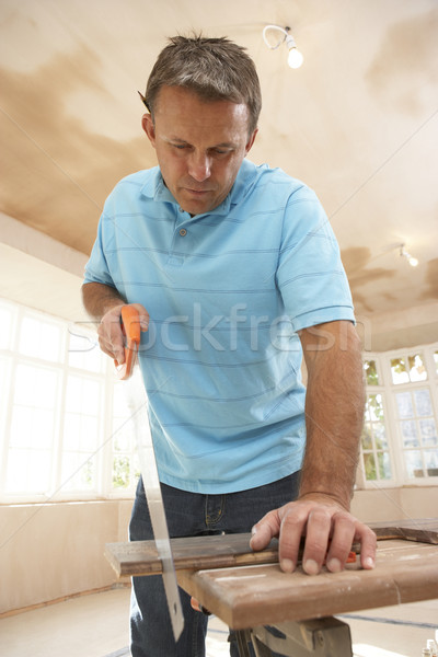 Builder Sawing Wood On Workbench Stock photo © monkey_business