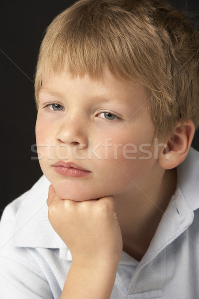 Stock photo: Studio Portrait Of Thoughtful Young Boy