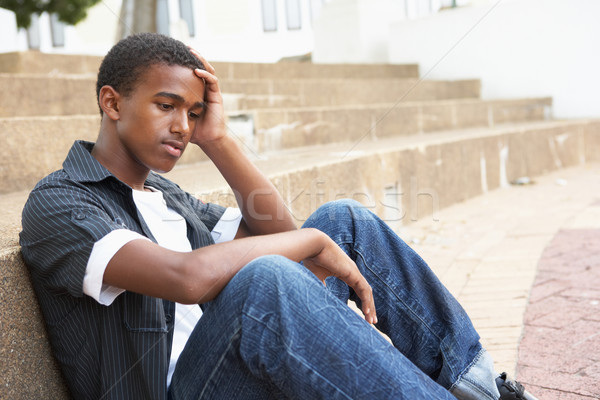 Malheureux Homme adolescent étudiant séance à l'extérieur Photo stock © monkey_business