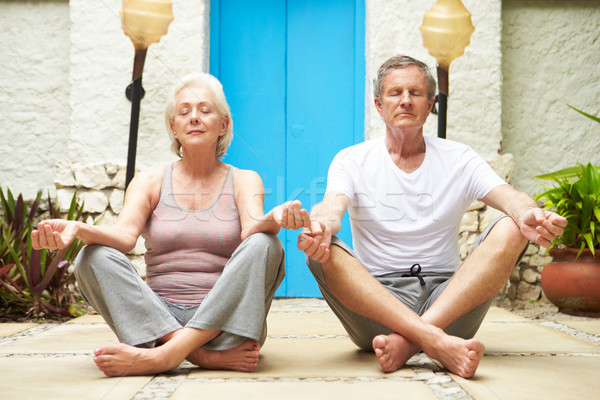 Senior Couple Meditating Outdoors At Health Spa Stock photo © monkey_business